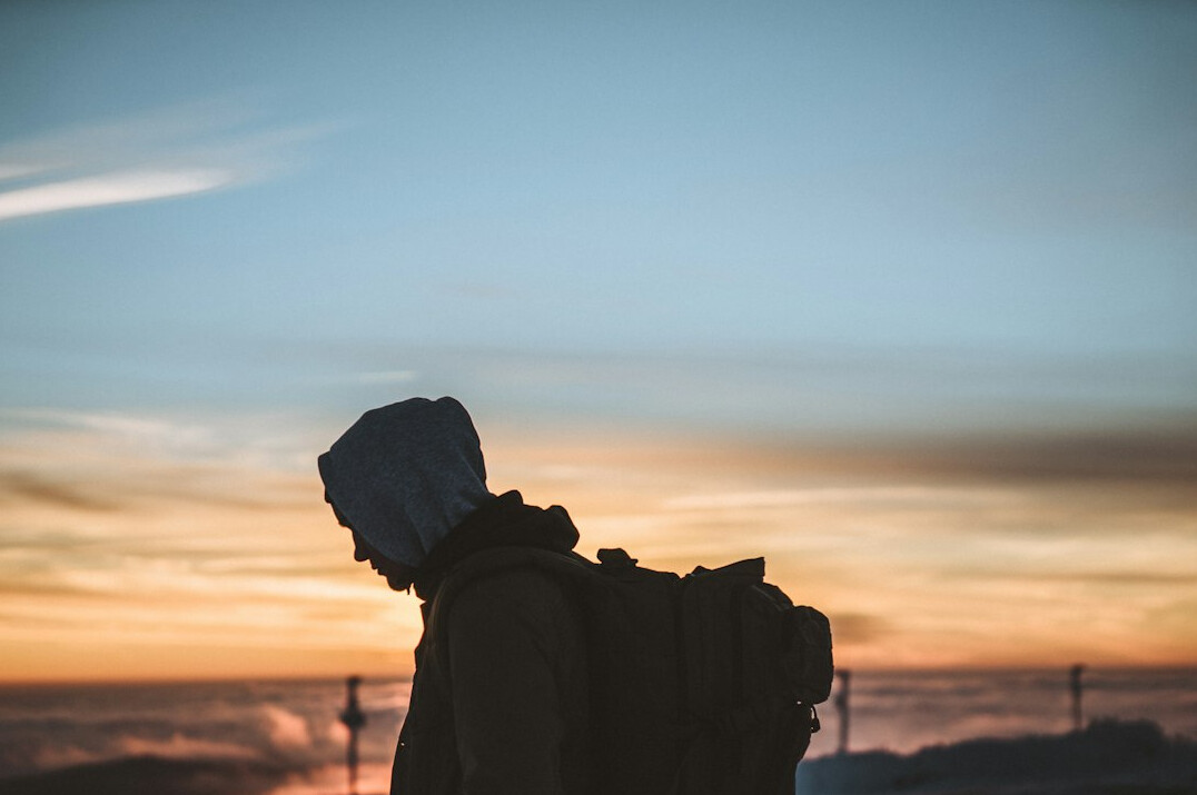 person looking at horizon at sunrise
